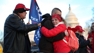 Gary Phaneuf, Tony Naples, and Melody Black visit a memorial for Ashli Babbitt near the U.S. Capitol.