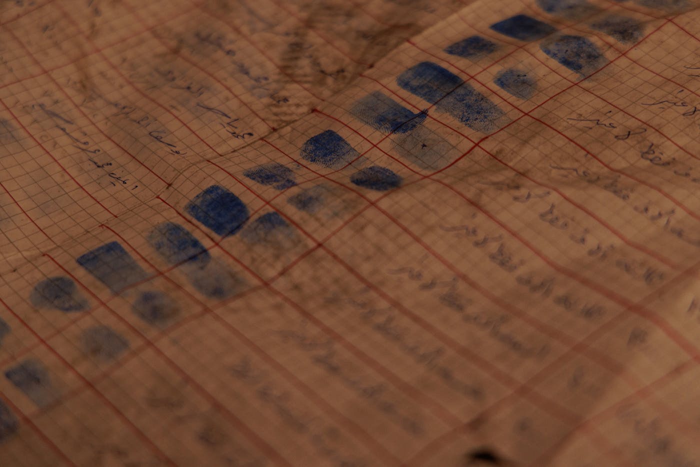 View of handwritten files with information about prisoners, which were recovered when rebel forces took over the prison. Many of the documents are in poor condition, nearly destroyed, with missing information, but searchers are still hopeful they can use them to locate prisoners in the facility—or at least who was there at a given period of time.