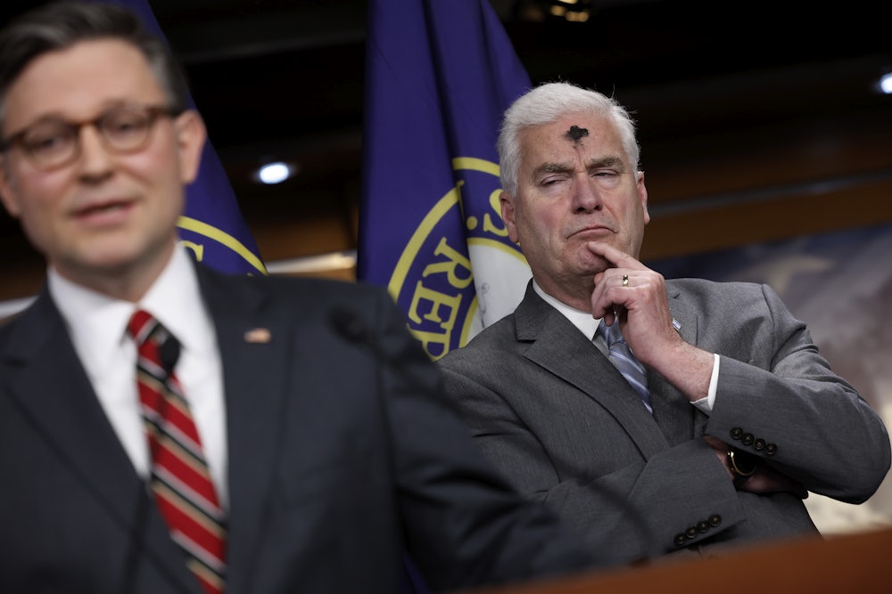 House Majority Whip Tom Emmer listens to House Speaker Mike Johnson