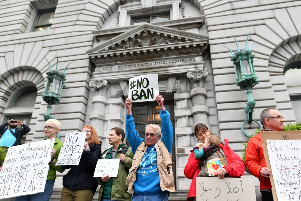 Protesters against President Donald Trump's proposed Muslim ban stand in front of the United States Court of Appeals for the Ninth Circuit in San Francisco, California on February 7, 2017.