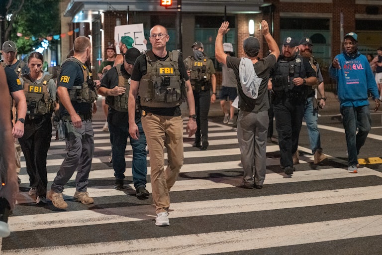 Protesters yell at federal troops in D.C. on Wednesday.