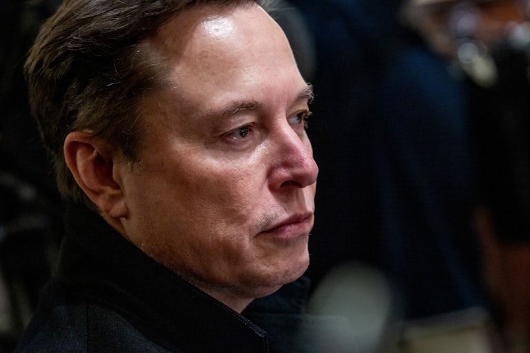 Elon Musk sits in Donald Trump’s Cabinet meeting and stares off forlornly.