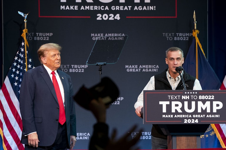 Donald Trump watches as Corey Lewandowski speaks at a campaign event