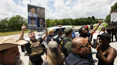 Pardoned January 6 rioter Jake Lang holds a sign that reads White Lives Matter while in a crowd outside the Collin County Courthouse.