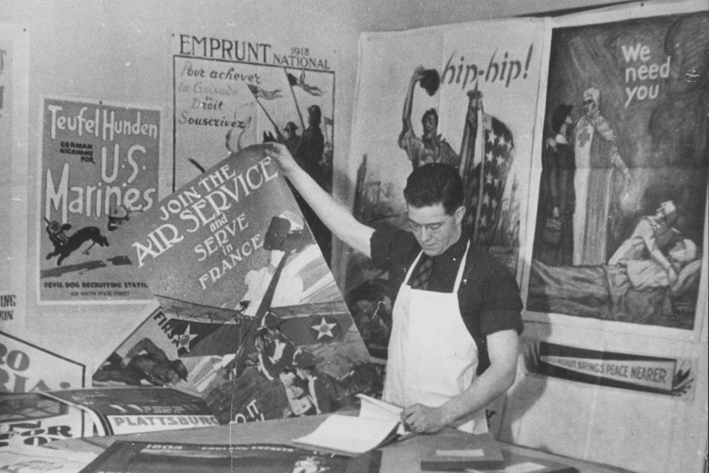 A Yale University student labels and sorts Army recruitment posters on campus during World War I