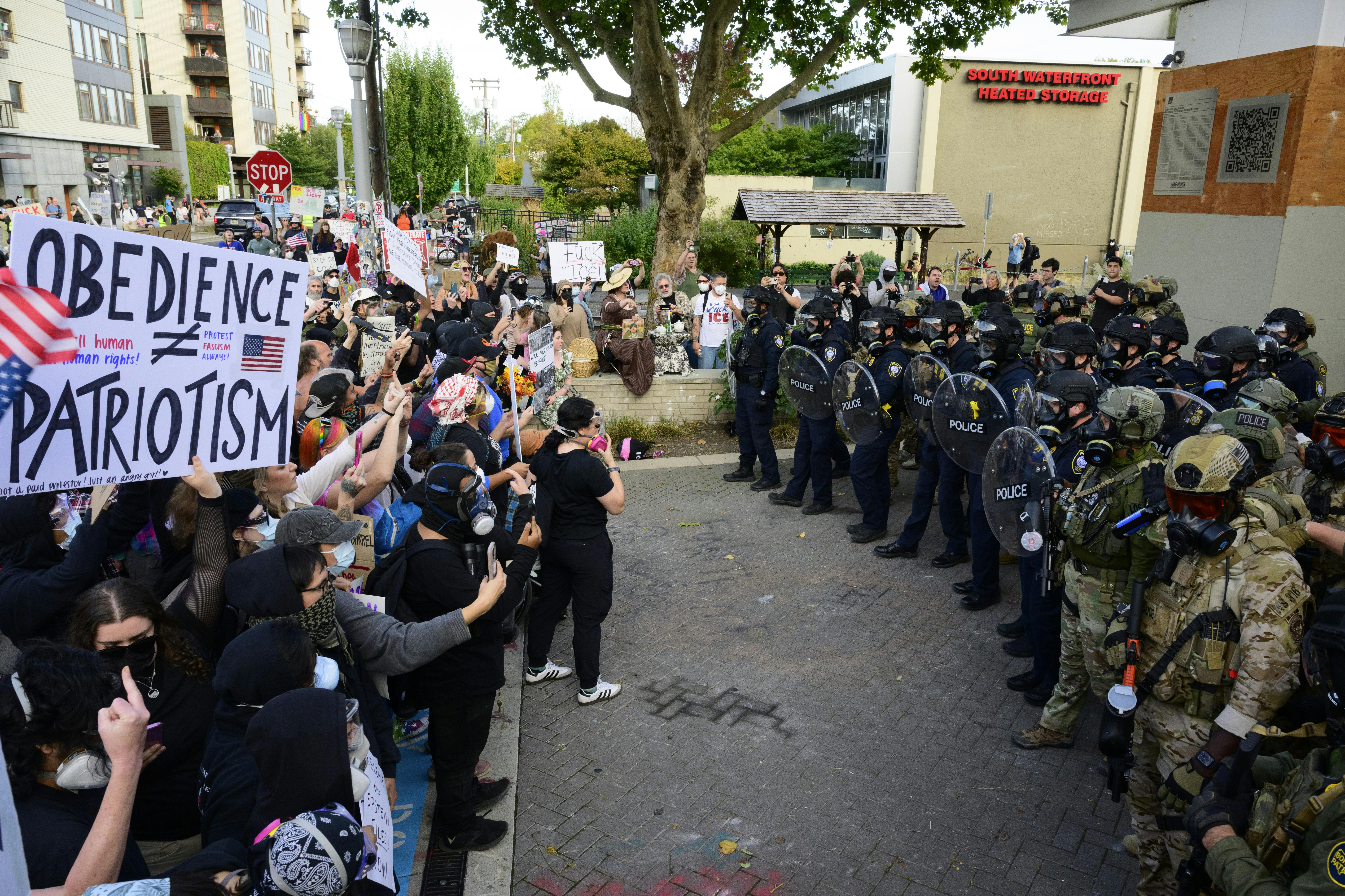 ICE agents and anti-ICE protesters outside an ICE facility in Portland 
