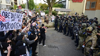 ICE agents and anti-ICE protesters outside an ICE facility in Portland