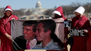 Protesters dressed as handmaids hold up a photo of Donald Trump and Jeffrey Epstein and signs that say, "SHAME" outside the White House