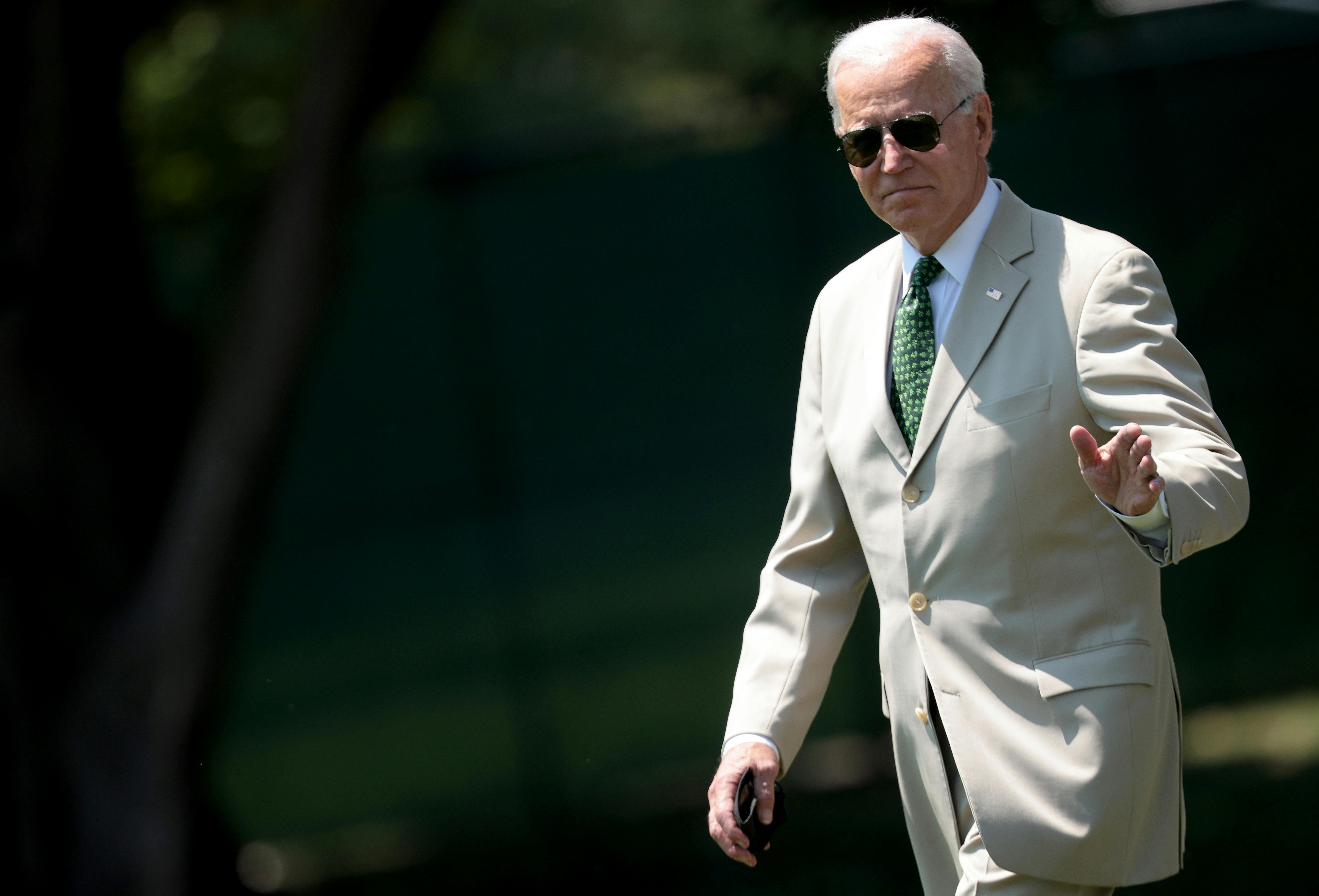 President Joe Biden waves as he departs the White House.
