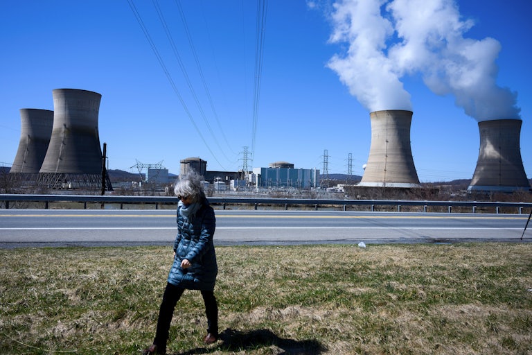 A woman walks past the nuclear plant on Three Mile Island.