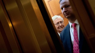 Senate Majority Leader Mitch McConnell departs on an elevator.