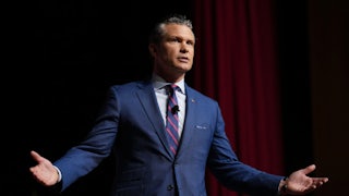 Pete Hegseth splays his arms out whiel speaking