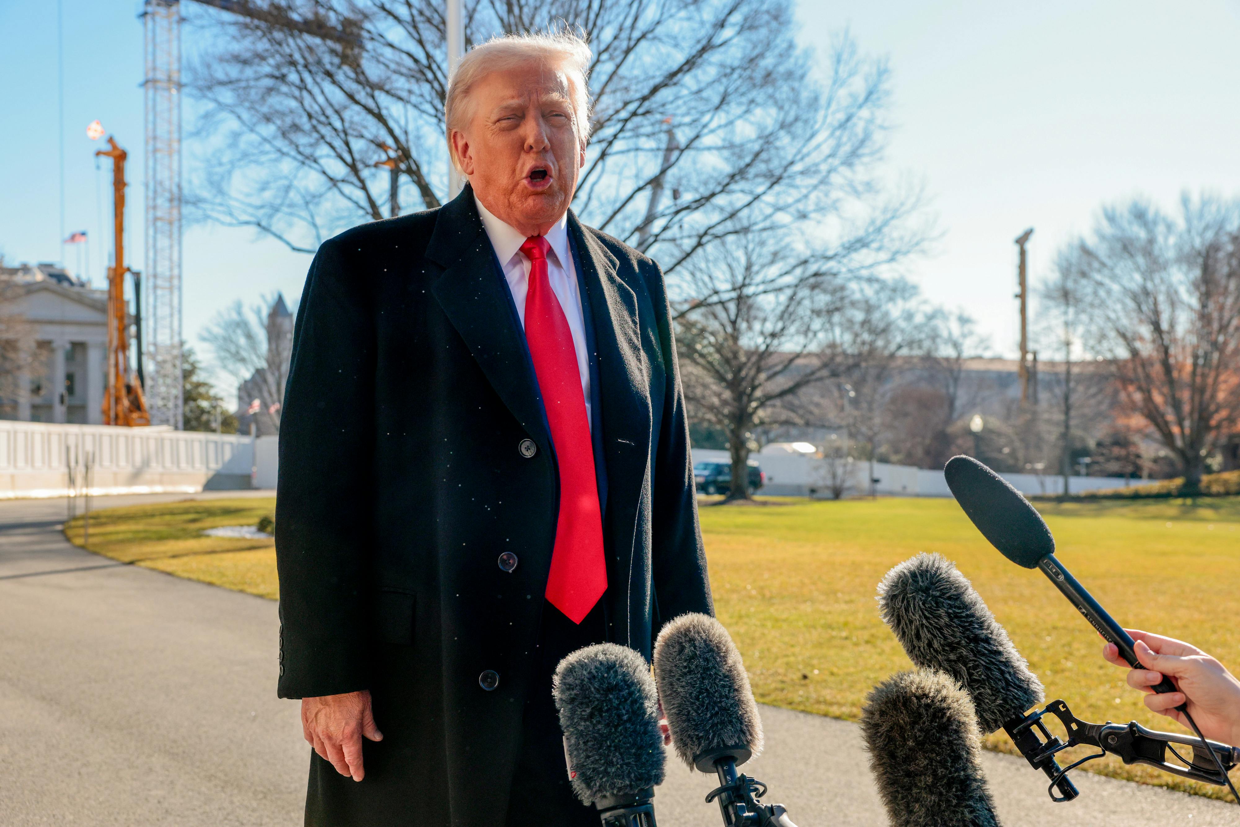 Donald Trump speaks to reporters on the White House lawn.