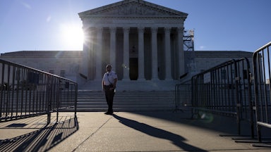 A security guard stands in front of the Supreme Court building