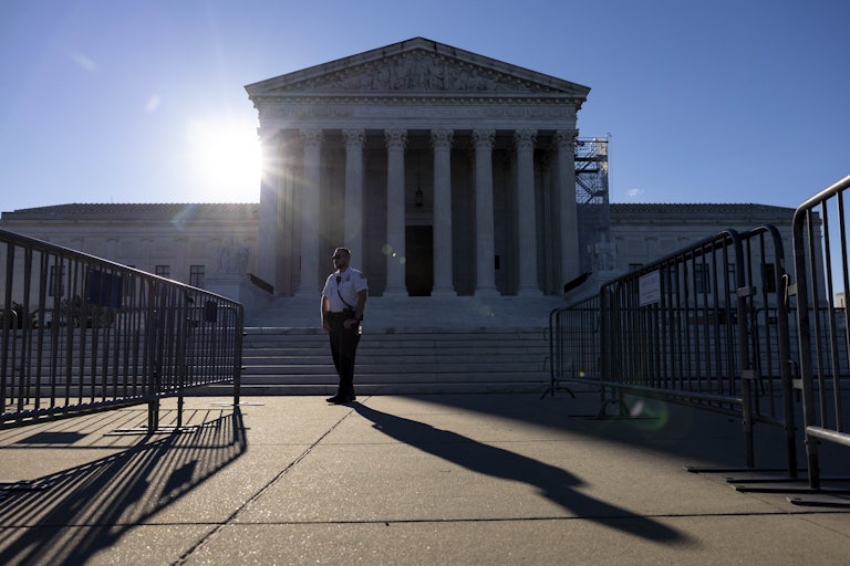 A security guard stands in front of the Supreme Court building