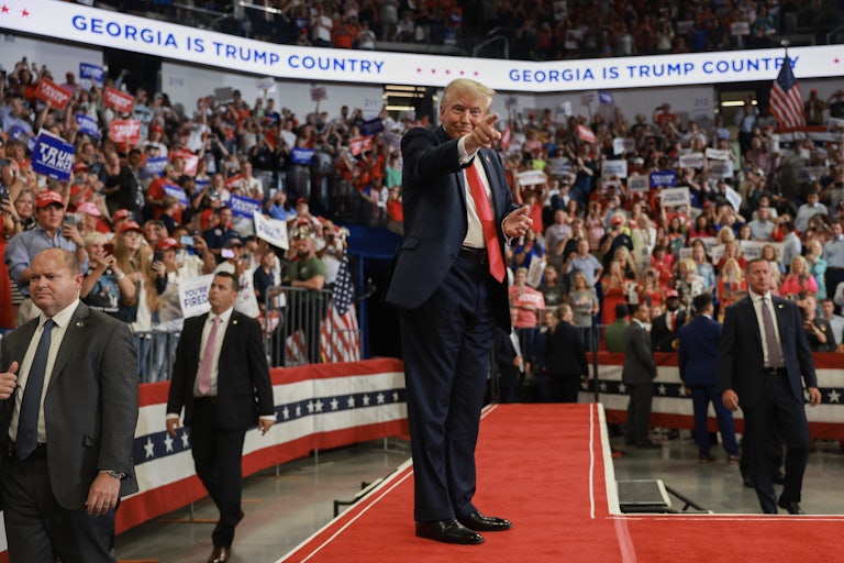 Donald Trump points at supporters during a rally in Georgia