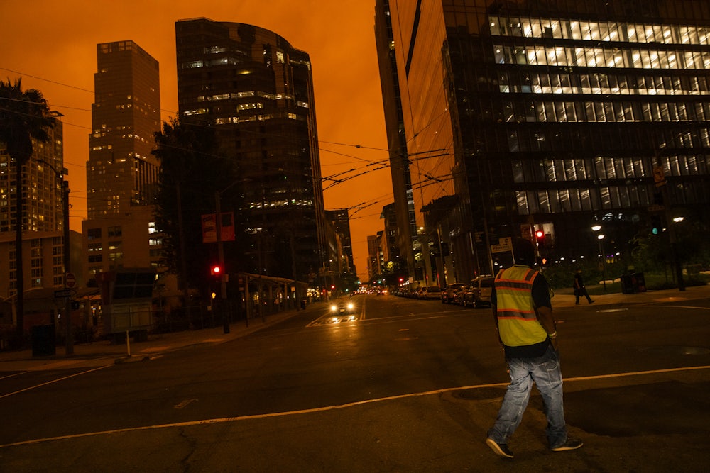 Downtown San Francisco is seen under an orange sky.
