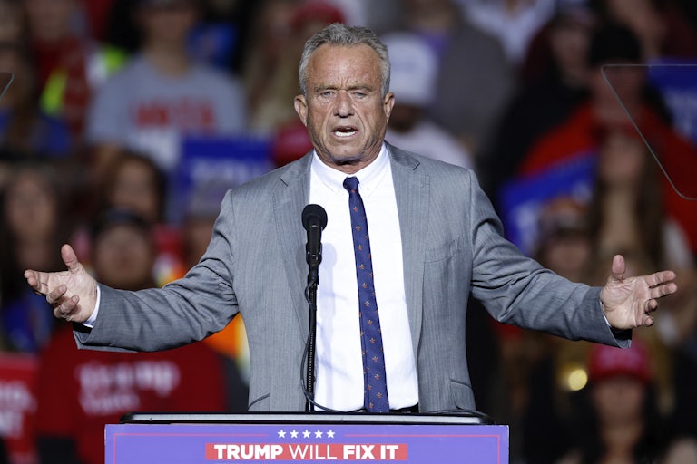 Robert F. Kennedy, Jr. holds his arms out while speaking at a Donald Trump event