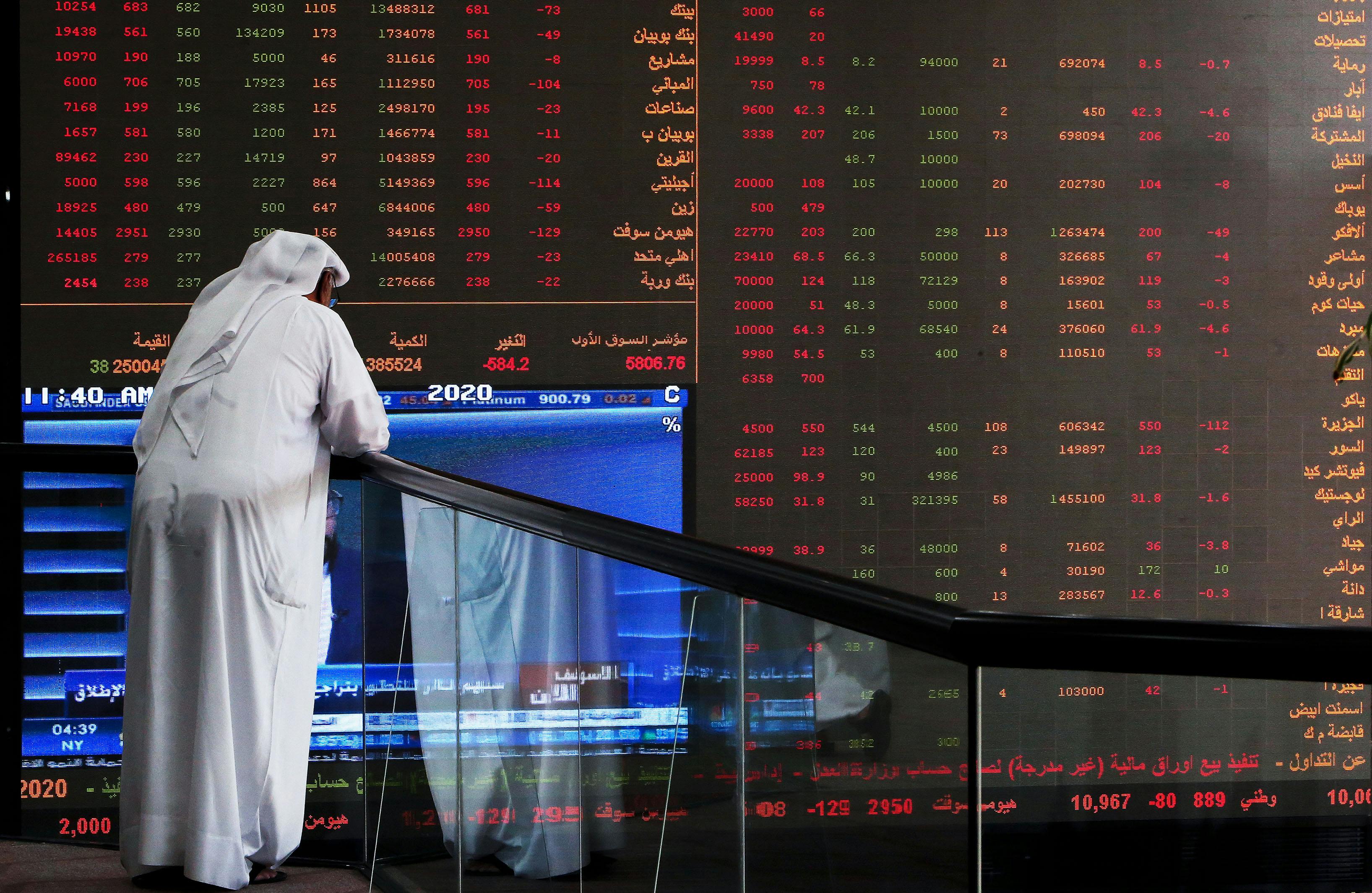 A Kuwaiti trader checks stock prices at Boursa Kuwait 