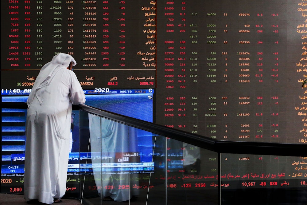 A Kuwaiti trader checks stock prices at Boursa Kuwait