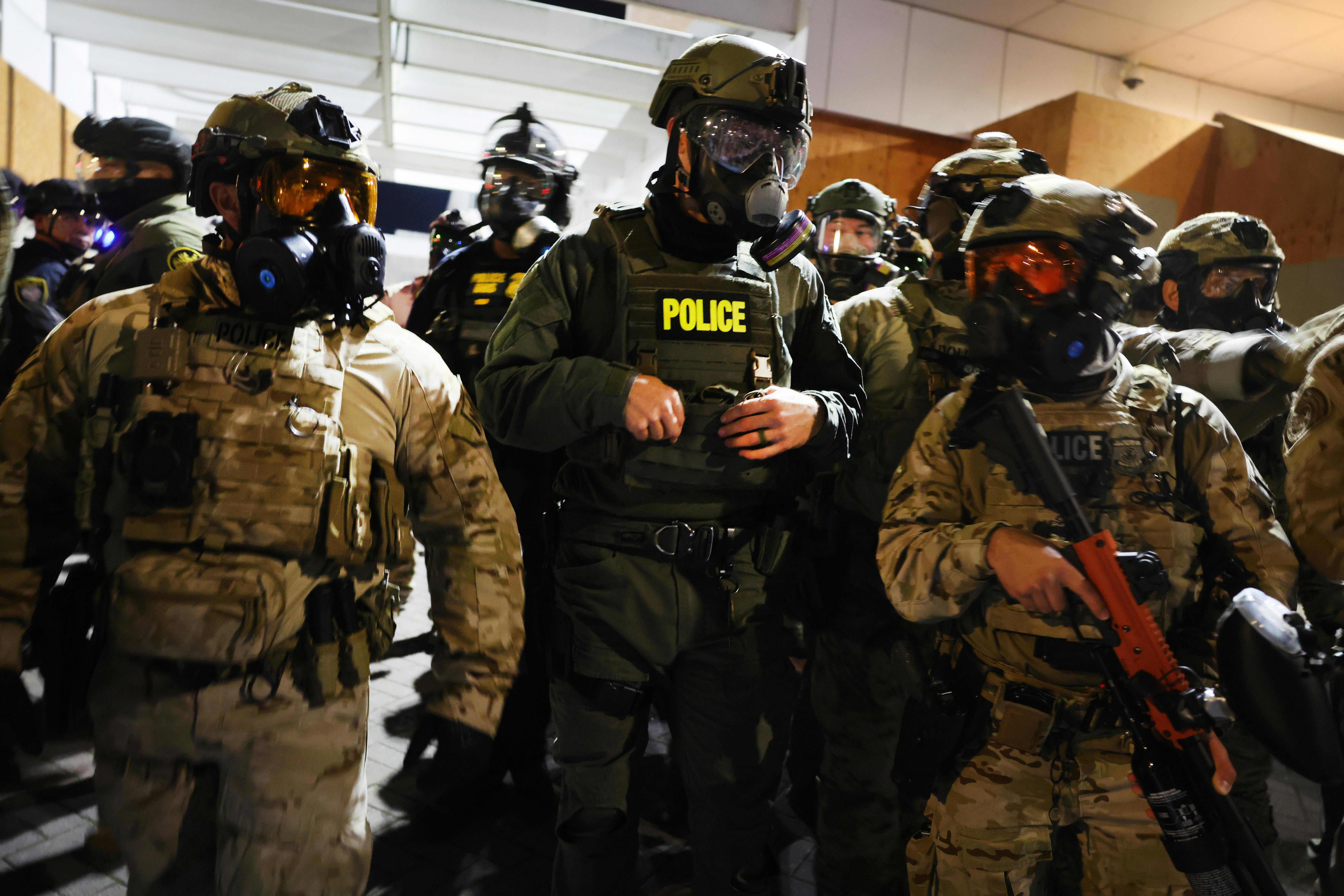 Federal agents in Portland wear gas masks and riot gear