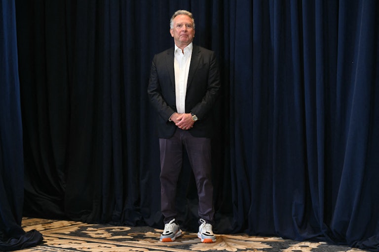 Steve Witkoff stands with his hands folded in front of his stomach