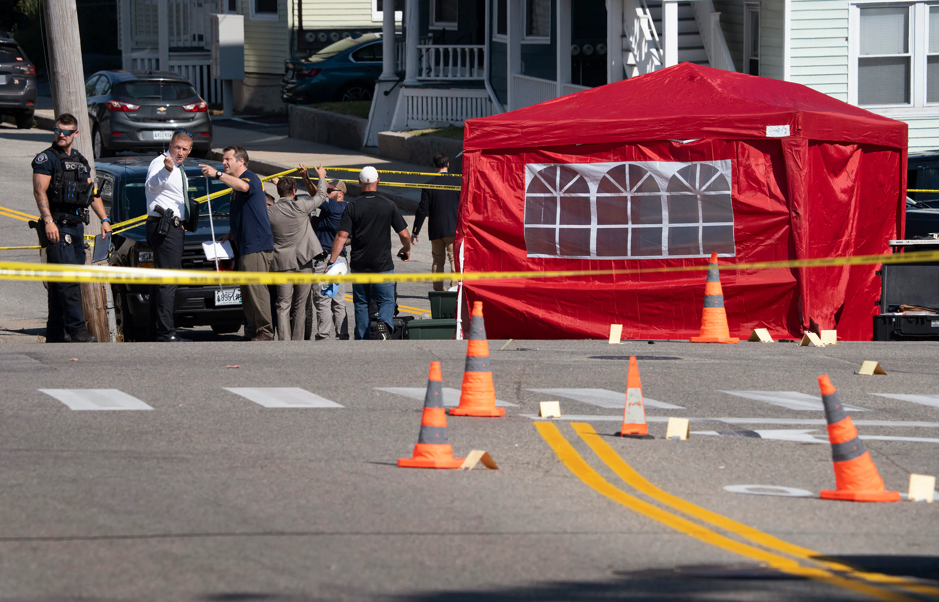 Officers gather at the scene in Biddeford, Maine, after an ICE agent killed a man.