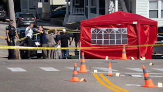 Officers gather at the scene in Biddeford, Maine, after an ICE agent killed a man.