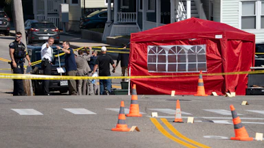 Officers gather at the scene in Biddeford, Maine, after an ICE agent killed a man.