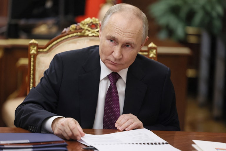 Vladimir Putin looks up from his desk