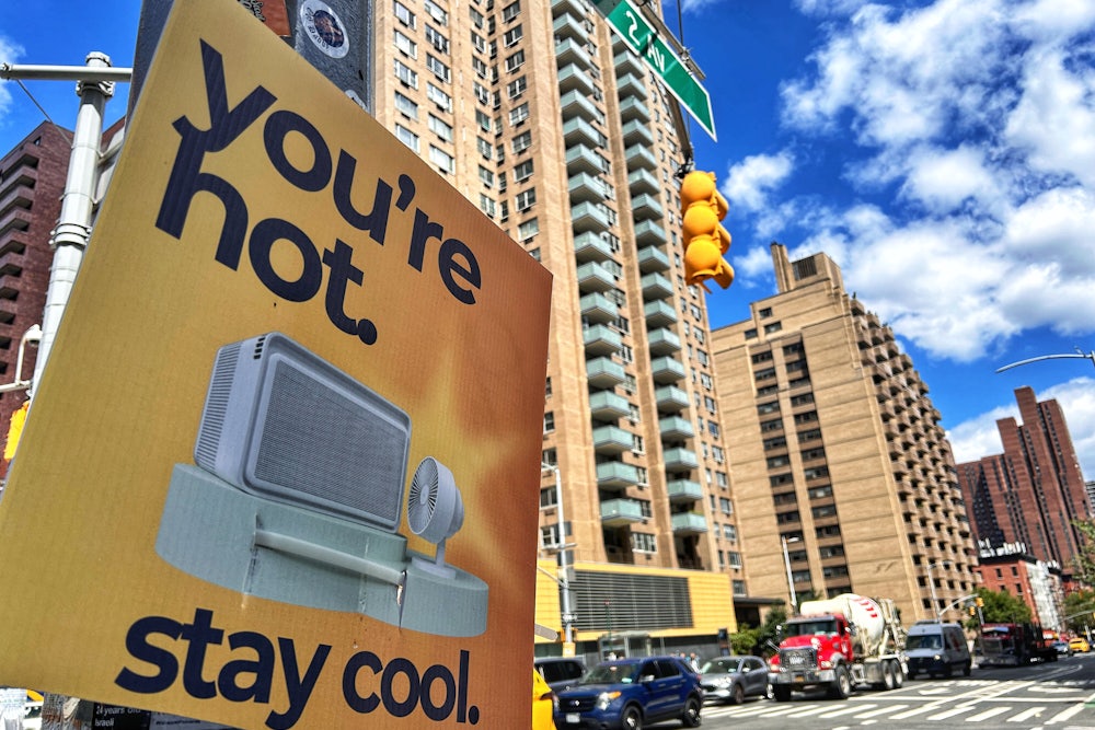 A sign saying "You're hot. Stay cool" affixed to a street light on 86th Street in Manhattan during a heatwave in August 2024.