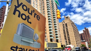 A sign saying "You're hot. Stay cool" affixed to a street light on 86th Street in Manhattan during a heatwave in August 2024.