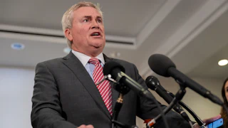 Representative James Comer speaks into reporters' microphones