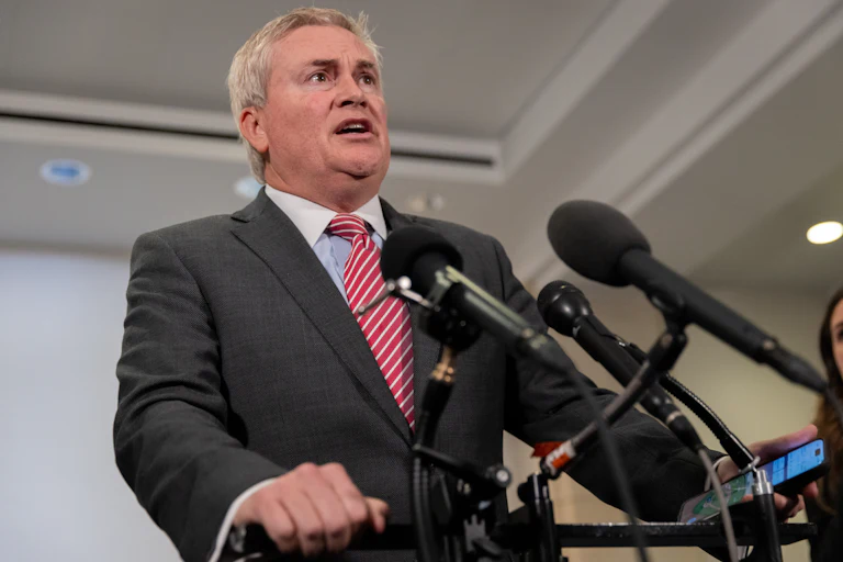 Representative James Comer speaks into reporters' microphones