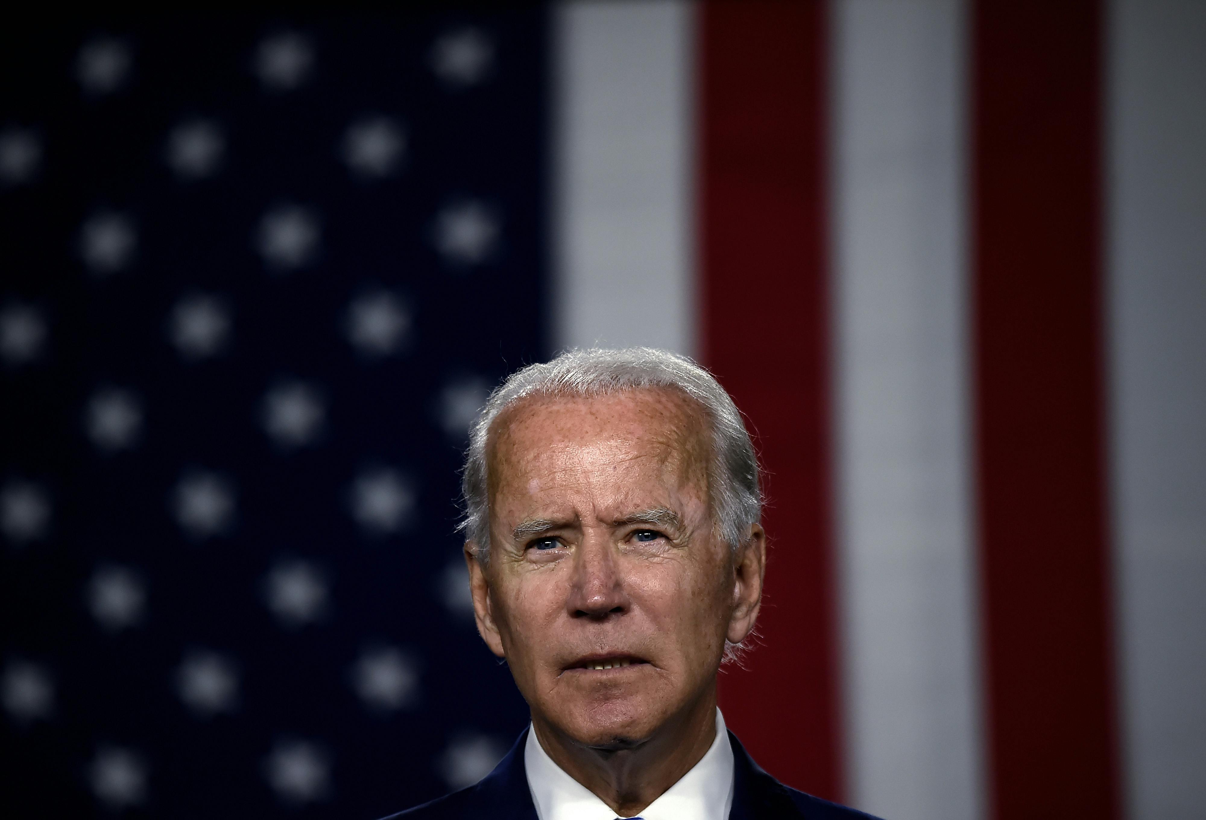 Biden speaks in front of American flag