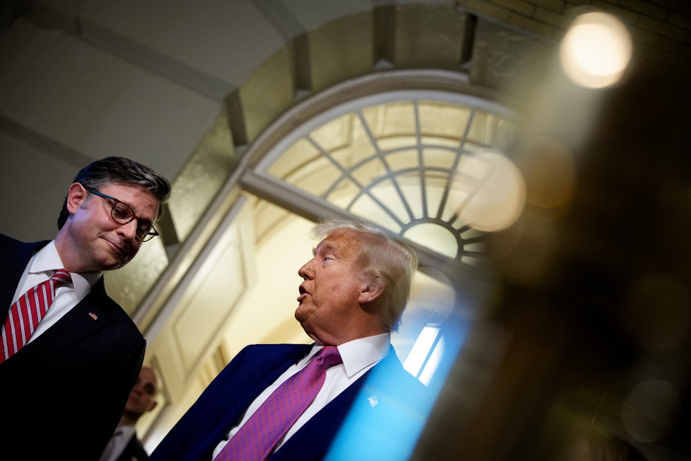 Donald Trump, accompanied by Speaker of the House Mike Johnson, speaks to members of the media.
