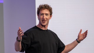 Mark Zuckerberg holds his arms out while talking.