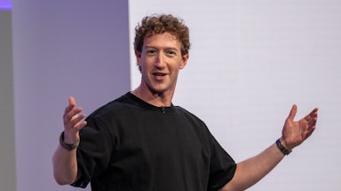 Mark Zuckerberg holds his arms out while talking.