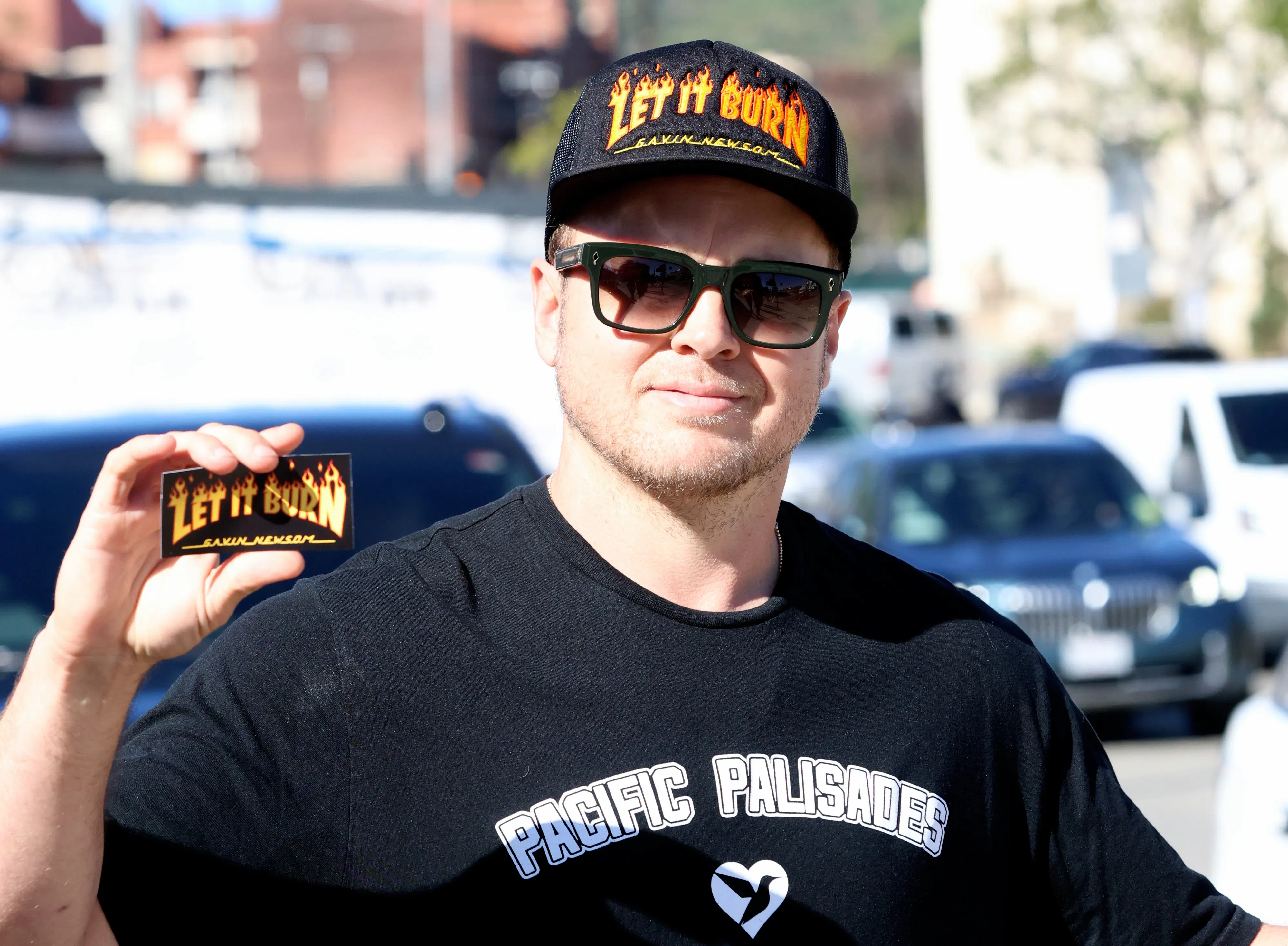 Spencer Pratt holds up a card reading "Let it Burn"