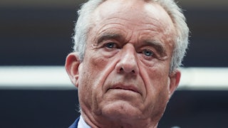Robert F. Kennedy looks down during a Senate subcommittee hearing