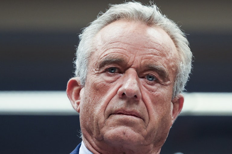 Robert F. Kennedy looks down during a Senate subcommittee hearing