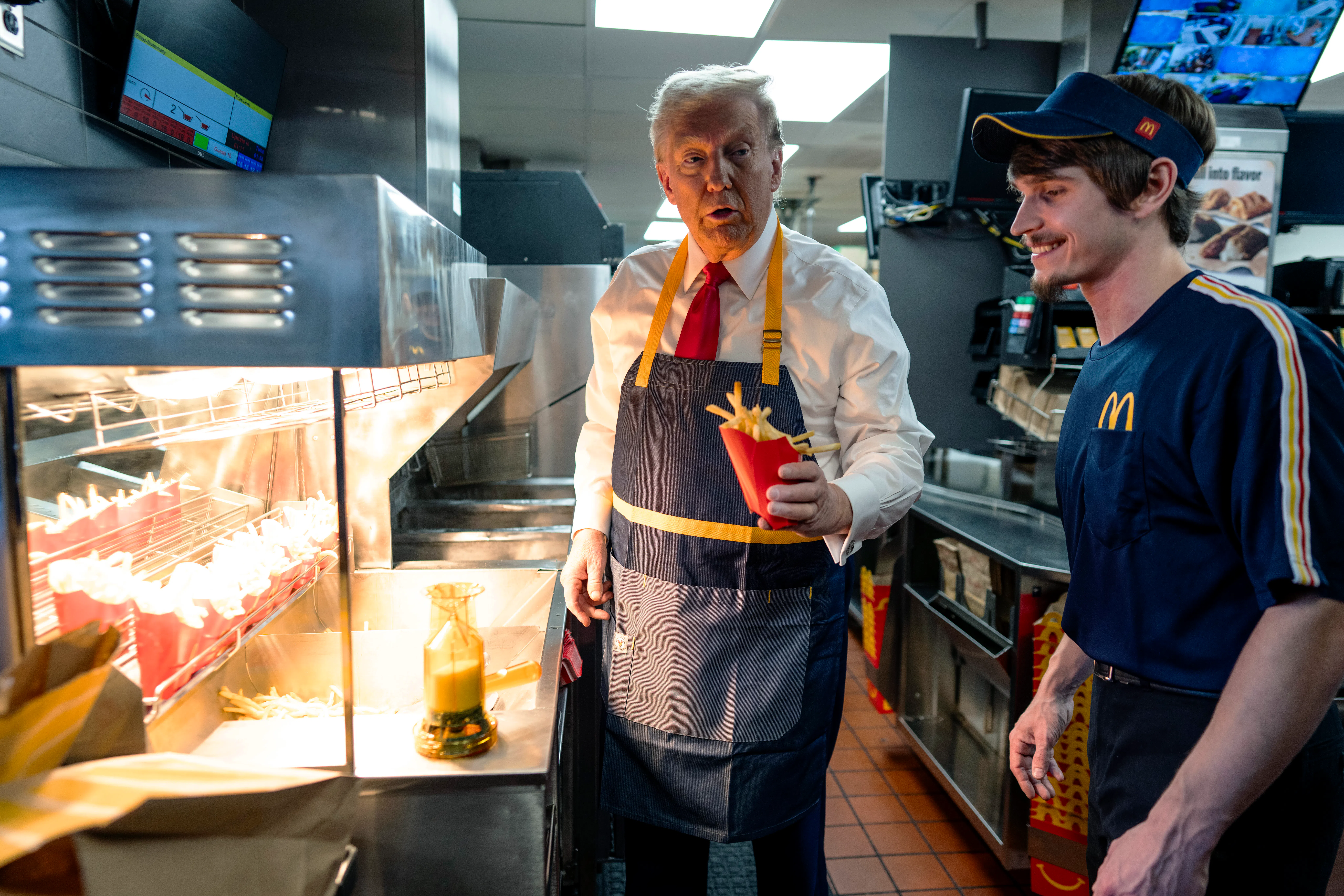 Donald Trump works behind the counter during a campaign event at McDonald's restaurant.