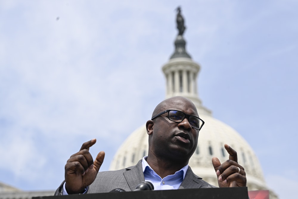 Jamaal Bowman speaks, with the Capitol building behind him.