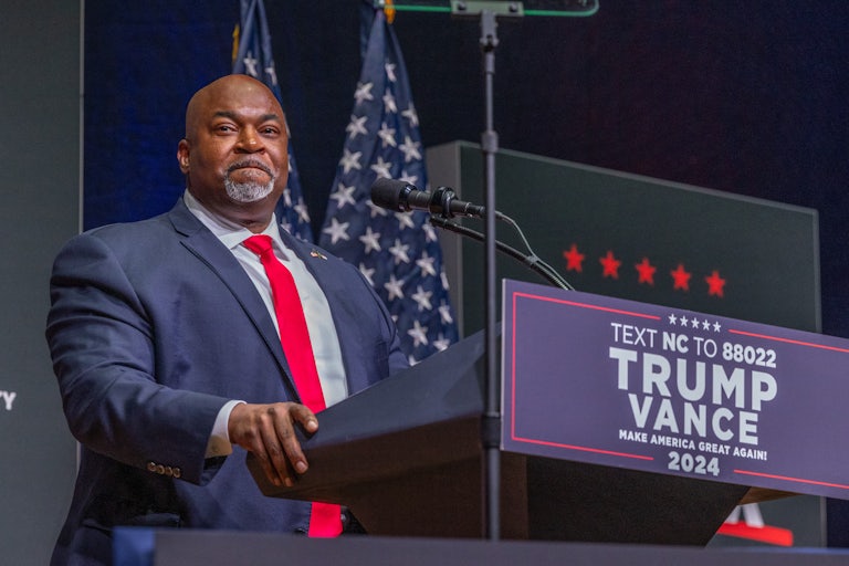 Mark Robinson stands at a podium during a Donald Trump rally