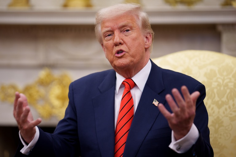 Donald Trump gestures while speaking in the Oval Office