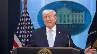 President Trump splays his arms out while speaking in the White House briefing room