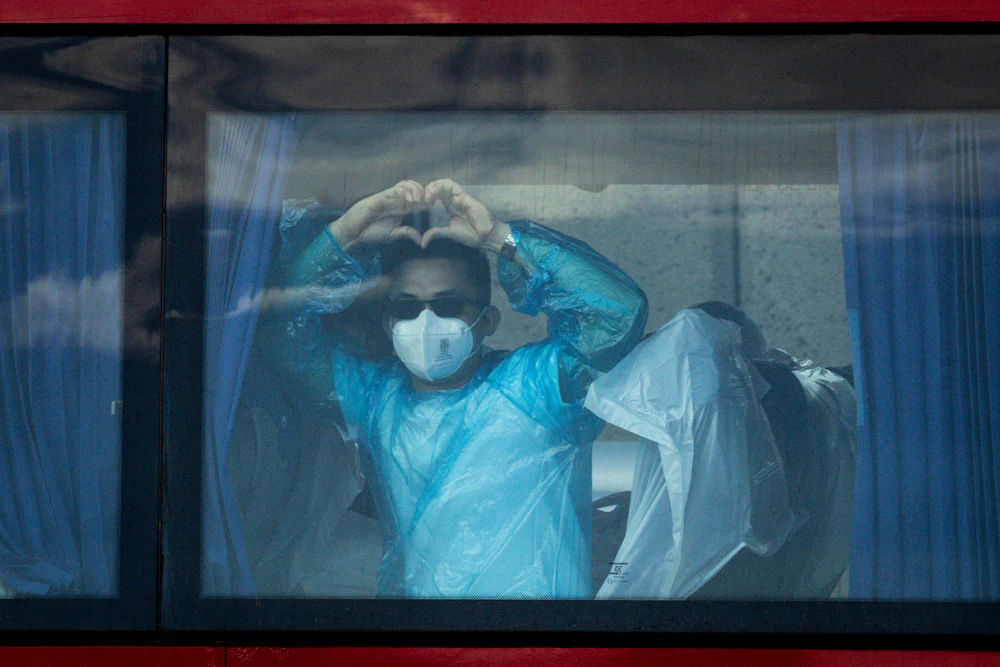 A passenger from the final group to be evacuated from the MV Hondius makes a heart from a bus on the way to the airport in the Granadilla Port in Tenerife, Spain. The MV Hondius had three passengers die from Hantavirus last month and eight more reported cases.