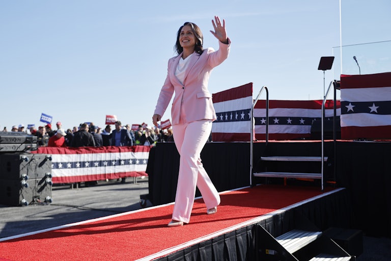 Tulsi Gabbard waves while walking at a Donald Trump rally