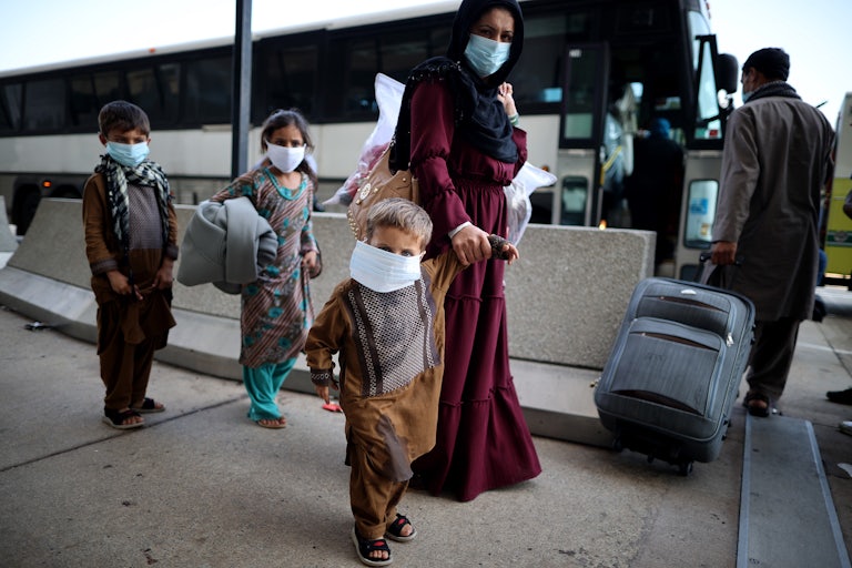 A mother and her three children arrive at Dulles International Airport after being evacuated from Afghanistan.