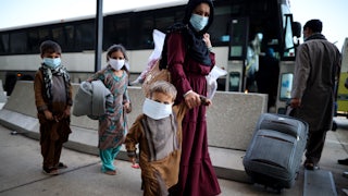 A mother and her three children arrive at Dulles International Airport after being evacuated from Afghanistan.